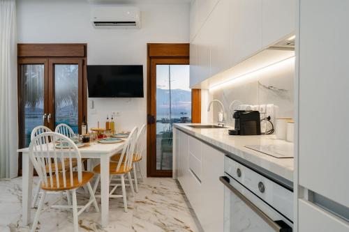 a kitchen with a table and chairs and a counter at Infinity View Apartment in Naxos Chora