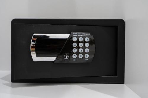 a black microwave with a remote control in it at Infinity View Apartment in Naxos Chora