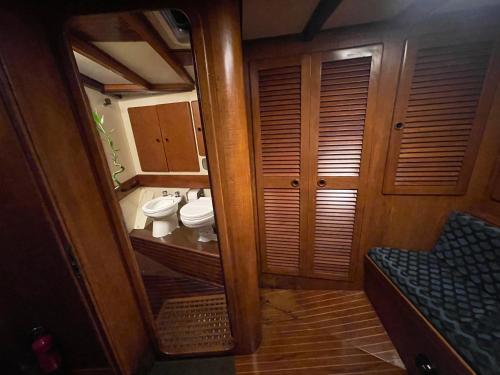 a small bathroom with two toilets and a mirror at SailBoat B&B on Board in Catania