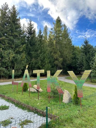 a bunch of signs in a field with a fence at Chalet Látky in Látky