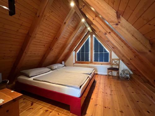 a bedroom with a bed in a wooden attic at Mueritzblick47 in Marienfelde