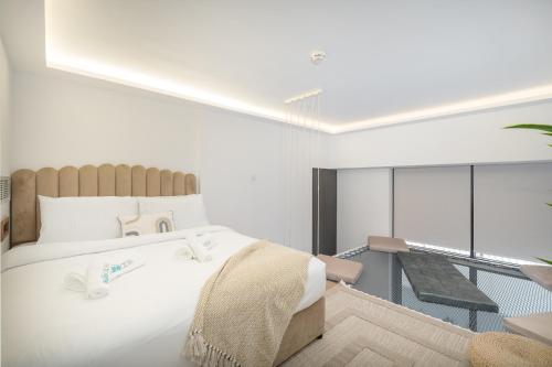 a bedroom with a large white bed and a balcony at Unique Loft design in JVC with relaxing in Dubai