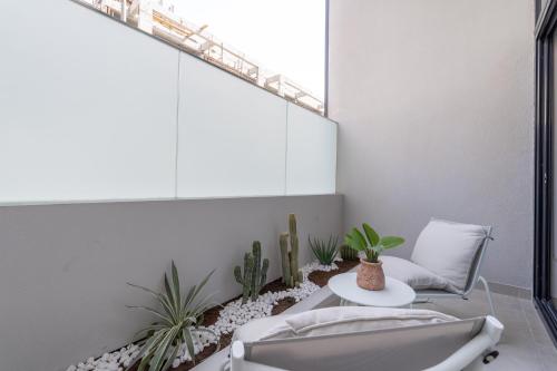 a bathroom with a chair and a table and plants at Unique Loft design in JVC with relaxing in Dubai