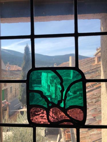 a stained glass window with a view of a city at Posada Real Mingaseda in Navafría