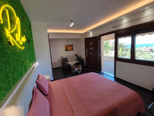 a room with a bed with a green wall at THEASIS 4 luxury studio with sea view in Neos Marmaras