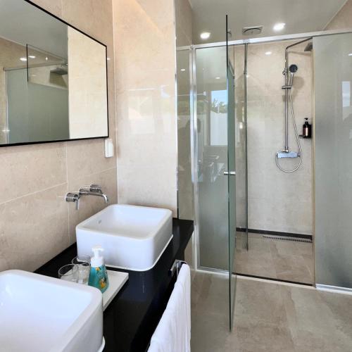 a bathroom with a sink and a shower at Jeju Breeze in Seogwipo