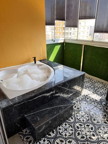 a bathroom with a large bath tub in a room at Mono Life Suitten Jakuzili Daire in Mersin