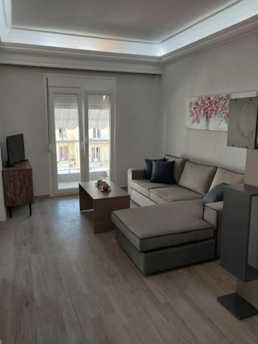 een woonkamer met een bank en een tv bij AniBo studios and apartments ZERO POINT 46 in Thessaloniki