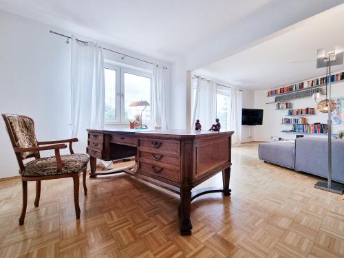 an office with a desk and a chair and a couch at Alpha Apartments in Essen