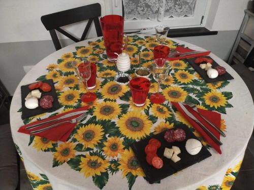 a table with sunflowers on top of it at LA TANA DELLA VOLPETTA - Bed & Breakfast in Stella