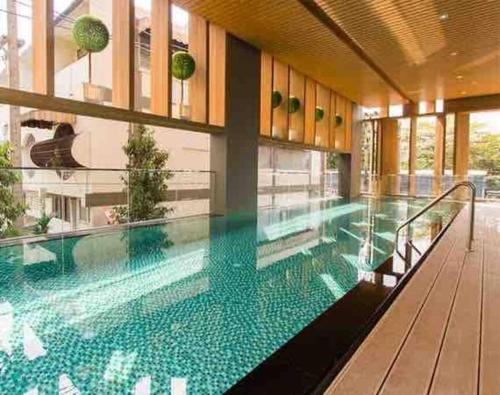 a large swimming pool in the middle of a building at Nimman Soi 5, Chiang Mai in Chiang Mai