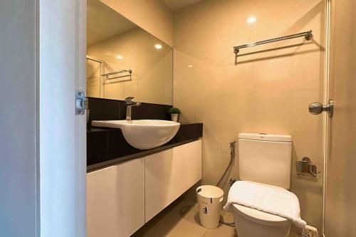 a bathroom with a sink and a toilet at Nimman Soi 5, Chiang Mai in Chiang Mai