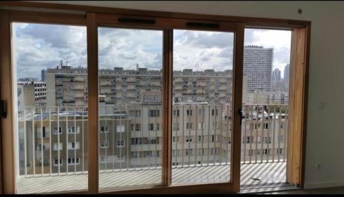 a view of a city skyline from a window at BeautifulParis18 in Paris