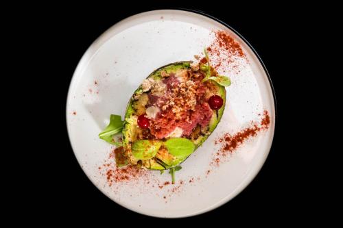 a white plate with a food dish on it at Hotel La Ville Rome in Rome