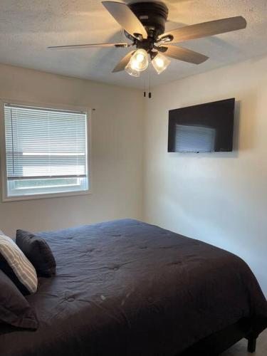 a bedroom with a bed and a ceiling fan at The Tranquility in Tobyhanna