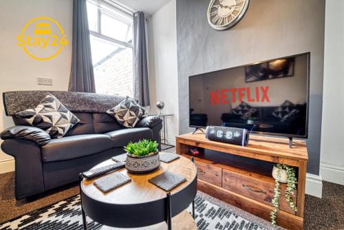 a living room with a couch and a tv at Cosy Carlton in Stoke on Trent