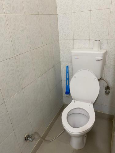 a bathroom with a white toilet in a room at Negi Lodge Chandigarh in Chandīgarh