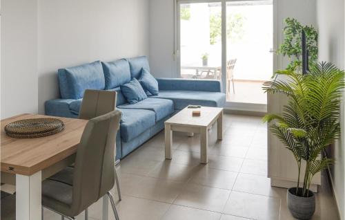 a living room with a blue couch and a table at Casa Fairview in Balsicas