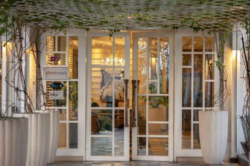 a front door of a store with glass doors at THE 1O1 Bogor Suryakancana in Bogor