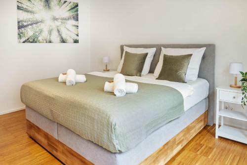 a bedroom with two beds with white towels on them at Design City Apartment, Modern, ebenerdig, Top Lage in Weinheim