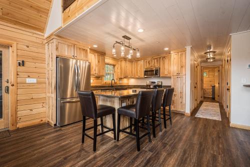 a kitchen with wooden cabinets and a stainless steel refrigerator at Moon and Stars in McHenry