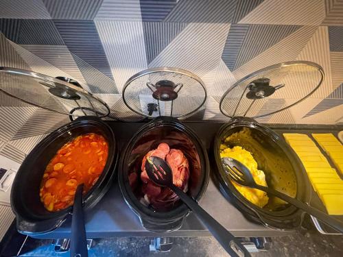 three bowls of different types of food on a shelf at Pousada Mar de Luna in Penha