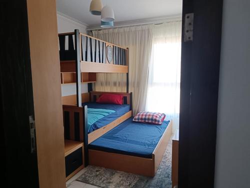 a small bedroom with a bunk bed and a ladder at شالية غرفتين و صالة ببورتوسعيد Family ONLY in Port Said