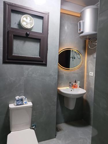 a bathroom with a toilet and a sink at شالية غرفتين و صالة ببورتوسعيد Family ONLY in Port Said