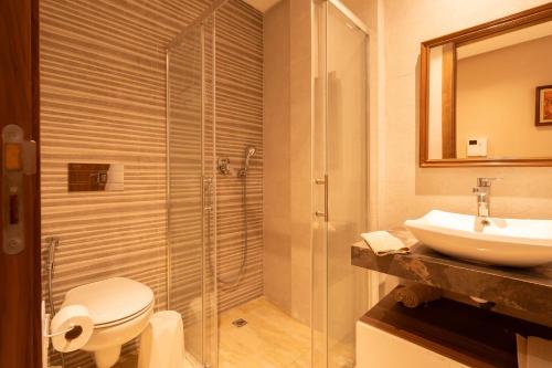 a bathroom with a toilet and a sink and a shower at Suite Apt Bourgogne N°2, 2 P in Casablanca