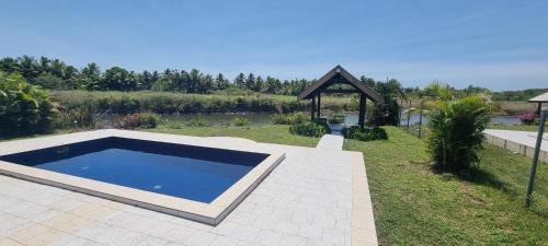 a swimming pool in a yard with a gazebo at Large 3 bedroom villa with Pool in Sonaisali Nadi in Nadi