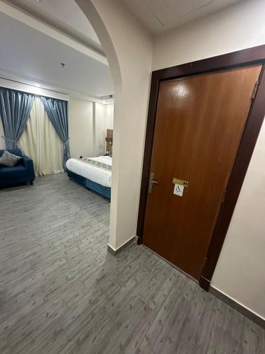 a hotel room with a door and a bed at PRIMOTEL Elite As Salamah - Serviced Apartments in Jeddah