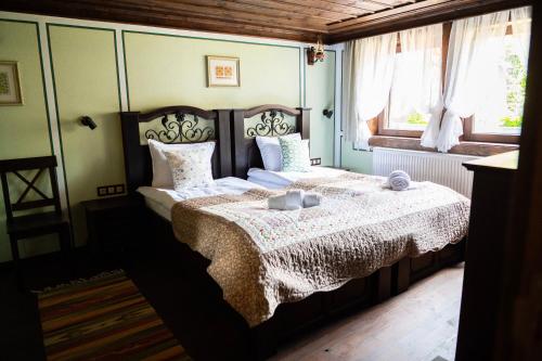 a bedroom with a bed and a window at Къща ЕТНО in Koprivshtitsa