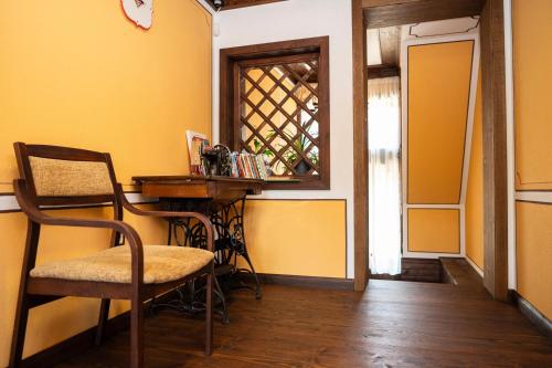 a room with a table and a chair and a window at Къща ЕТНО in Koprivshtitsa