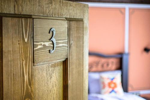 a wooden door with a number on it in a bedroom at Къща ЕТНО in Koprivshtitsa