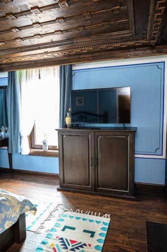 a living room with a flat screen tv on a wall at Къща ЕТНО in Koprivshtitsa