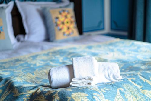 two rolls of towels sitting on a bed at Къща ЕТНО in Koprivshtitsa