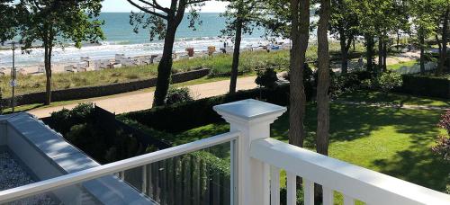 a balcony with a view of a beach and the ocean at Villa Svanen am Meer in Timmendorfer Strand
