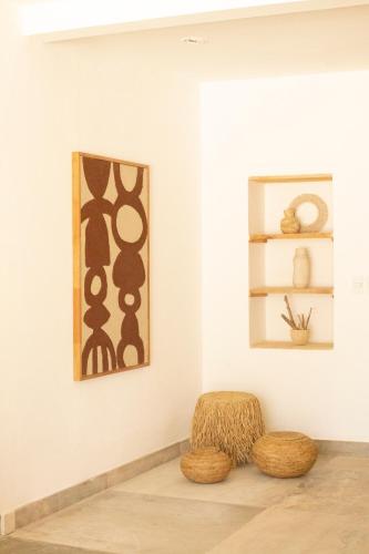 a room with a chair and paintings on the wall at m a r ė a in José Ignacio