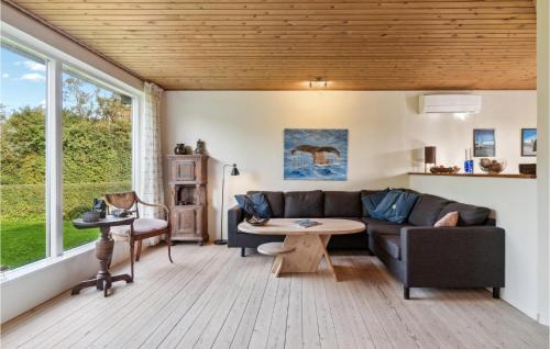 a living room with a couch and a table at Awesome Home In Føllenslev With Wifi in Føllenslev