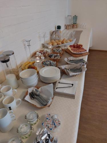 a long table with plates and dishes on it at Hotel Gästehaus Altena in Altena
