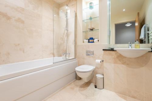 a bathroom with a toilet and a sink and a shower at Parkview, St Andrews in St. Andrews