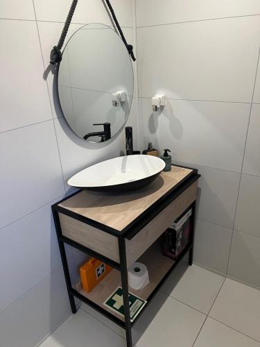 a bathroom with a sink and a mirror at Francisca City House in Vila Nova de Gaia