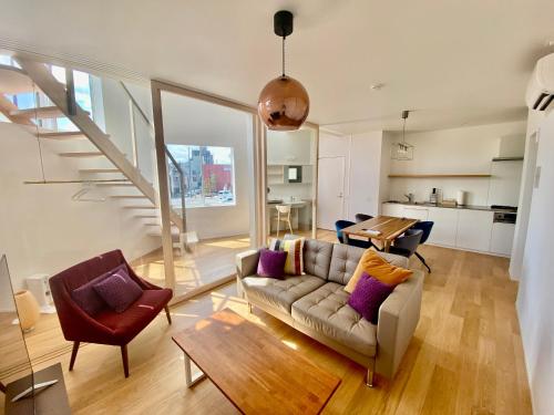 a living room with a couch and a table at Villa Monica EAST in Nagoya