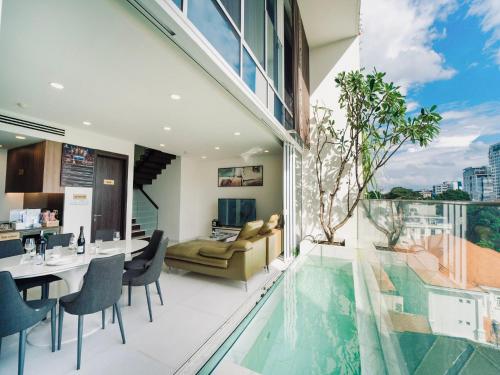 a dining room and living room with a swimming pool at Serenity Private Pool Sky Villas in Ho Chi Minh City