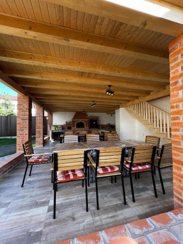 a patio with benches and a table and stairs at Casa Bujor de Munte Dragoslavele in Dragoslavele