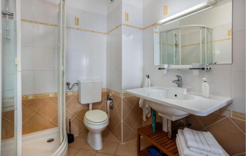 a bathroom with a toilet and a sink and a shower at 2 Bedroom Lovely Apartment In Lovran in Lovran