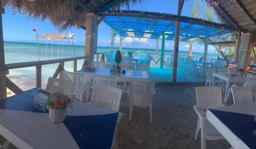 a restaurant on the beach with tables and chairs at La Isla Bonita in Punta Rucia
