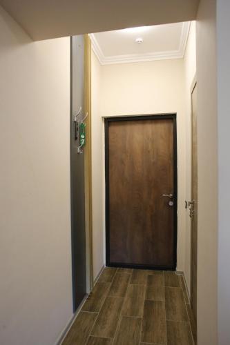 a hallway with a brown door and a wooden floor at RIVER SIDE in Polyana