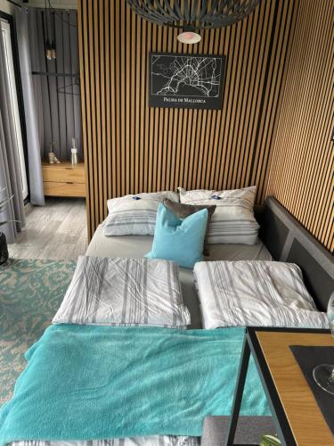 two beds in a room with a wall with stripes at Tinyhouse mit Alpen- Stadt- und Poolblick , WLAN in Passau