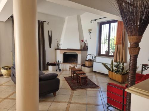 a living room with a couch and a fireplace at Casa Sbrizza in Rosolini